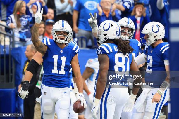 The Indianapolis Colts celebrate a touchdown by Michael Pittman in the first half against the Tennessee Titans at Lucas Oil Stadium on October 31,...