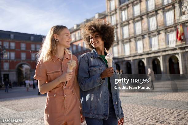 small happy diverse group of girlfriends enjoying an ice cream in madrid - madrid stock pictures, royalty-free photos & images