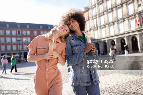 small happy diverse group of girlfriends enjoying an ice cream in madrid - madrid people stock pictures, royalty-free photos & images