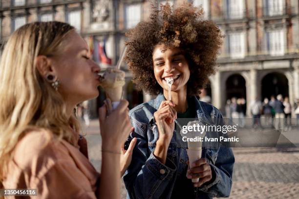 small happy diverse group of girlfriends enjoying an ice cream in madrid - madrid food stock pictures, royalty-free photos & images