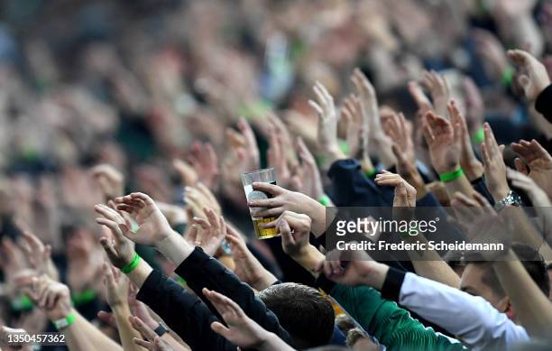 Fans show their support as one holds a beer during the Bundesliga match between Borussia Mönchengladbach and VfL Bochum at Borussia-Park on October...
