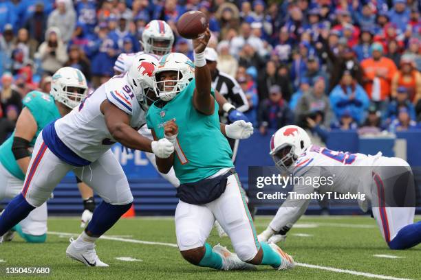 Tua Tagovailoa of the Miami Dolphins throws a pass while being chased by Ed Oliver of the Buffalo Bills in the second quarter at Highmark Stadium on...