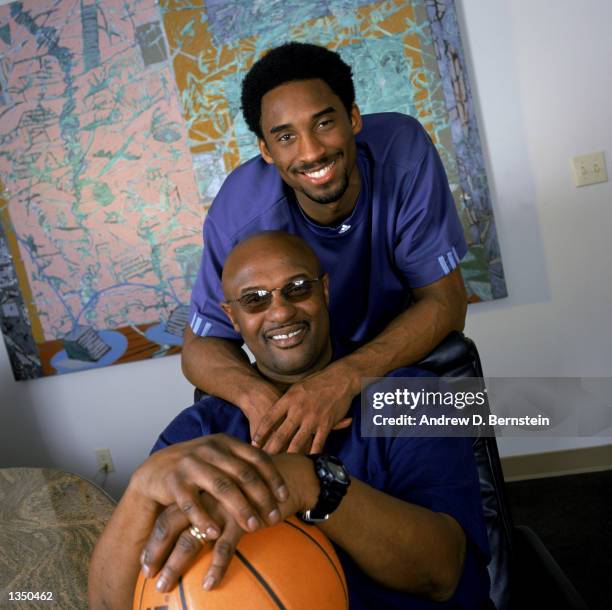 Guard Kobe Bryant of the Los Angeles Lakers poses for a portrait with his father, former NBA player Joe "Jellybean" Bryant, after purchasing a 50...