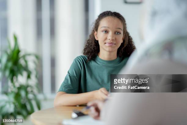 teen in a therapy session - teen and doctor stock pictures, royalty-free photos & images