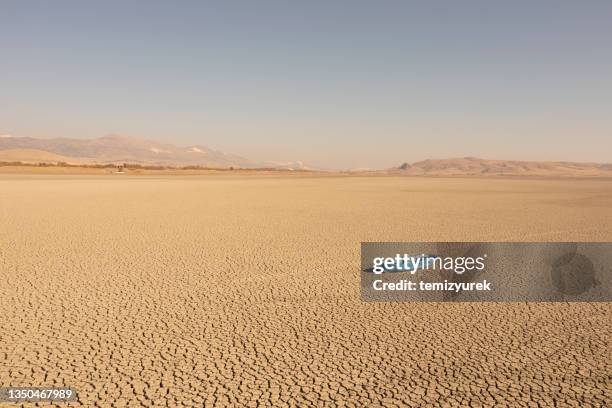 aerial view of a fishing boat on a drought dry lakebed. - extreme weather desert stock pictures, royalty-free photos & images