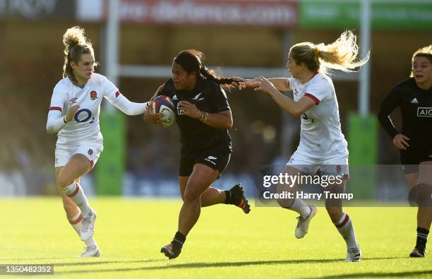 Ayesha Leti-I'iga of New Zealand is tackled by Abby Dow and Ellie Kildunne of England during the Autumn International match between England Red Roses...