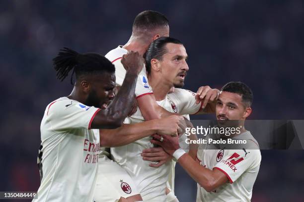 Zlatan Ibrahimovic of AC Milan celebrates with team mates after scoring their side's first goal during the Serie A match between AS Roma and AC Milan...