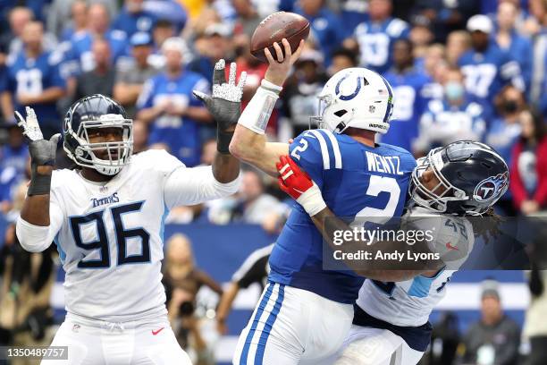 Joe Jones of the Tennessee Titans tackles Carson Wentz of the Indianapolis Colts as he throws an interception during the second half at Lucas Oil...