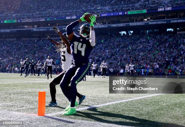 Metcalf of the Seattle Seahawks catches the ball over Shaquill Griffin of the Jacksonville Jaguars for a touchdown during the second quarter at Lumen...