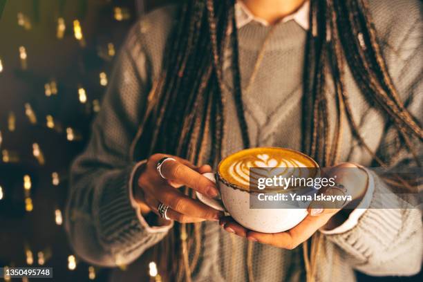 a woman holding a christmas coffee cup with rosetta latte art close-up - christmas coffee stock pictures, royalty-free photos & images