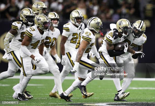 Chauncey Gardner-Johnson of the New Orleans Saints celebrates with teammates after intercepting a pass by Tom Brady of the Tampa Bay Buccaneers...