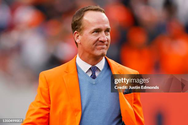 Peyton Manning looks on during a Ring of Honor induction ceremony at halftime of the game between the Washington Football Team and Denver Broncos at...