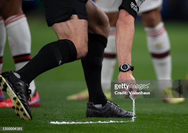 Referee Stuart Attwell uses his vanishing spray during the Premier League match between Tottenham Hotspur and Manchester United at Tottenham Hotspur...
