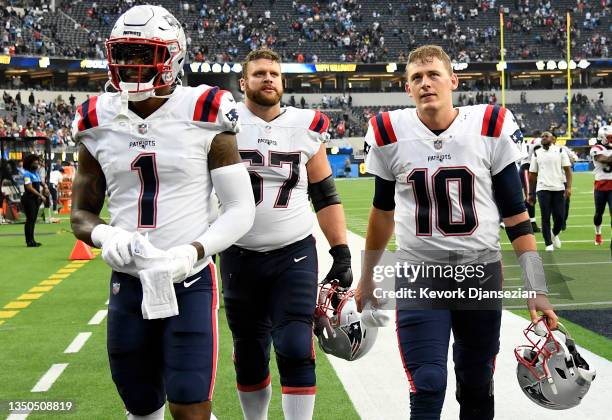 Keal Harry, Ted Karras, and Mac Jones of the New England Patriots walk off the field after the New England Patriots beat the Los Angeles Chargers...