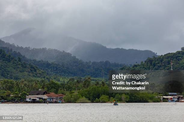 salak phet bay (koh chang island) - rain cloud, mountain, rain forest and fisherman village) - fishing village stock pictures, royalty-free photos & images