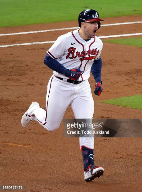 Adam Duvall of the Atlanta Braves celebrates as he rounds the bases after hitting a grand slam home run against the Houston Astros during the first...
