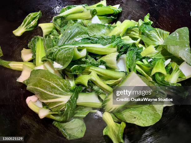 preparing sidedish or vegetarian meal from bok choy green vegetable - chinese cabbage stock pictures, royalty-free photos & images