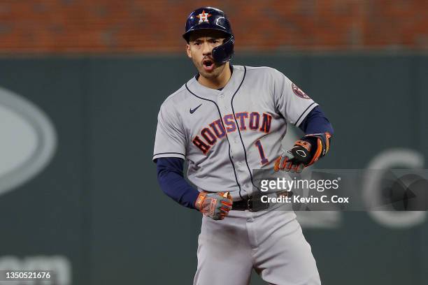 Carlos Correa of the Houston Astros celebrates after hitting an RBI double against the Atlanta Braves during the third inning in Game Five of the...