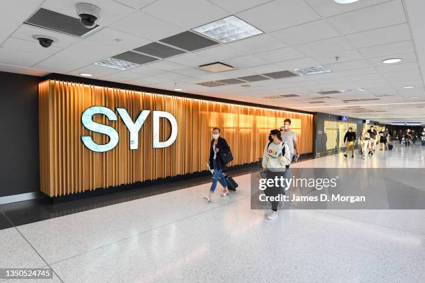Passengers arrive from their overseas flights and walk to the arrivals hall after landing at Sydney Airport on November 01, 2021 in Sydney,...