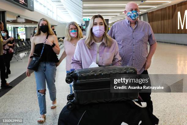 Family is reunited as an international traveler walks through at Melbourne Airport International arrivals hall on November 01, 2021 in Melbourne,...