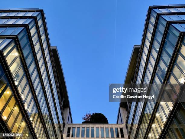 modern office building with  glass walls at dusk - apartment budapest stock pictures, royalty-free photos & images