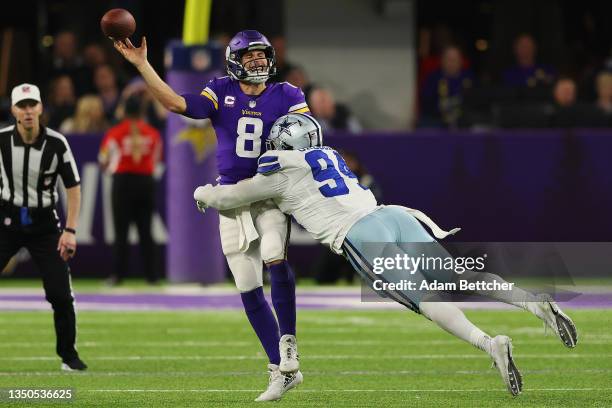 Kirk Cousins of the Minnesota Vikings throws a pass under pressure from Randy Gregory of the Dallas Cowboys during the fourth quarter at U.S. Bank...