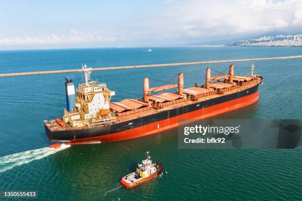 aerial view of large bulk carrier approaching port. - bulk carrier stock pictures, royalty-free photos & images