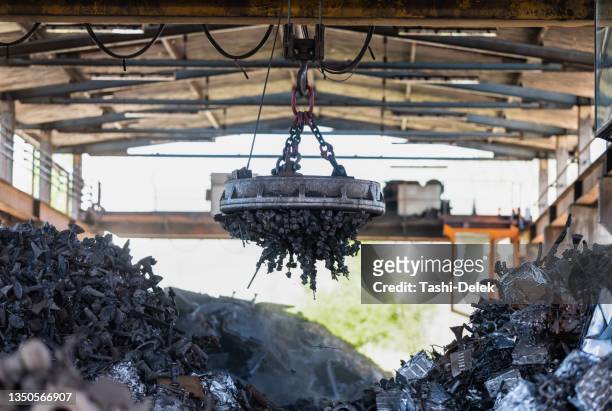 transporting scrap steel by crane, recycling of material - steel bildbanksfoton och bilder
