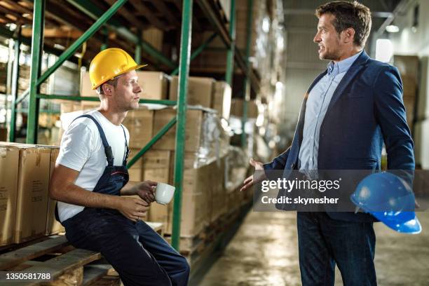 frustrated inspector arguing with his worker in distribution warehouse. - industrial dispute stock pictures, royalty-free photos & images
