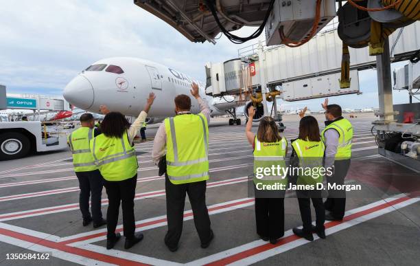 Qantas staff wave goodbye to a Qantas Boeing 787 Dreamliner aircraft as she prepares to push back at Sydney Airport en route to London via Darwin on...