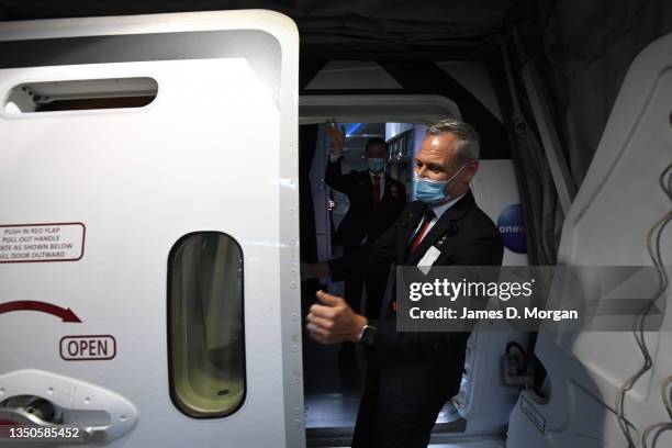 Qantas crew member waves goodbye as another staff member closes the door to QF1, a Boeing 787 Dreamliner aircraft at Sydney Airport en route to...