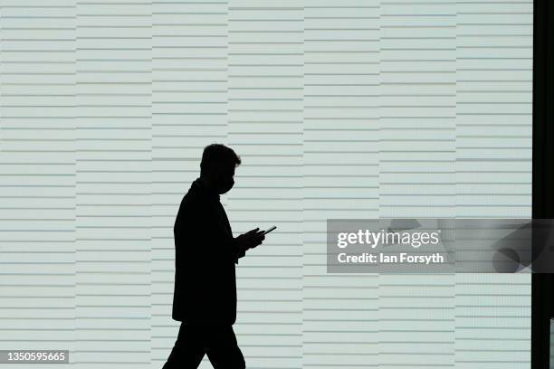 Man checks his phone as he attends on day two of the COP 26 United Nations Climate Change Conference at SECC on November 01, 2021 in Glasgow,...