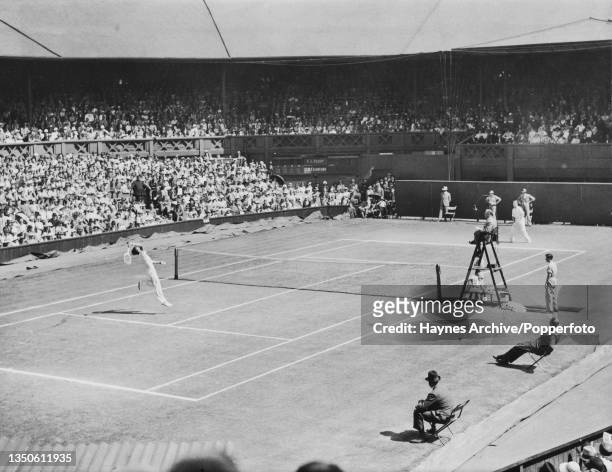 British tennis player Fred Perry returns the shot from Australian tennis player Jack Crawford on Centre Court during their Men's Singles Final match...