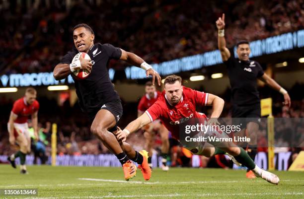 Sevu Reece of New Zealand scores a try under pressure from Owen Lane of Wales during the Autumn International match between Wales and New Zealand at...