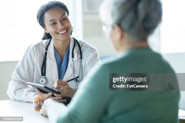 obtaining a patients health history - fatcamera doctor stock pictures, royalty-free photos & images