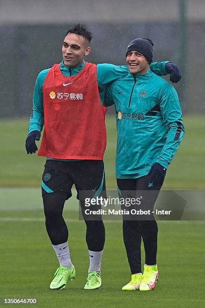 Lautaro Martinez of FC Internazionale embraces his teammate Alexis Sanchez of FC Internazionale during the FC Internazionale training session at the...