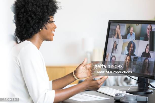 female financial advisor gestures during meeting with company employees - telecommuting stock pictures, royalty-free photos & images