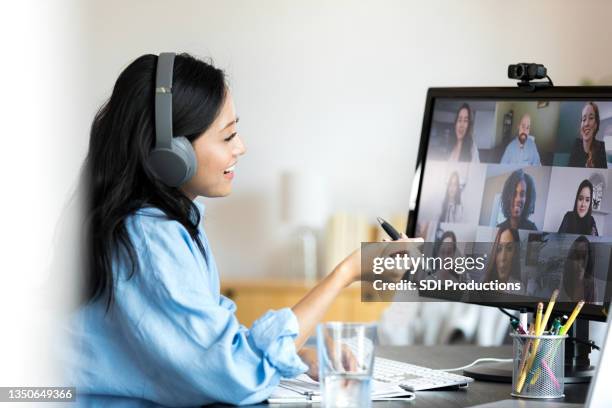 mid adult teacher smiles and gestures while teaching online class - teacher zoom stock pictures, royalty-free photos & images