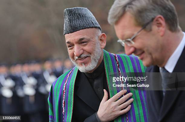 German President Christian Wulff and Afghan President Hamid Karzai finish reviewing a guard of honour upon Karzai's arrival at Bellevue Palace on...