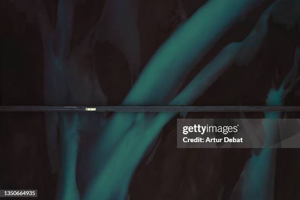 drone view of a car crossing a bridge in iceland with blue steams of glacier water. - green vanishing point stock pictures, royalty-free photos & images