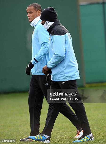 Manchester City's Belgian midfielder Vincent Kompany and Ivorian defender Kolo Toure arrives for a training session in Manchester on December 6, 2011...