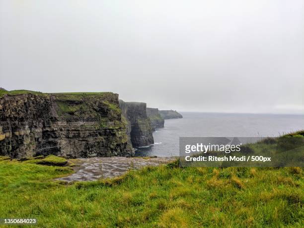 scenic view of sea against sky,dublin,ireland - cliff edge stock pictures, royalty-free photos & images