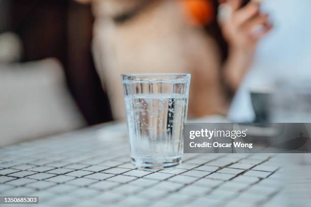 close-up of a glass of water served on table in restaurant - carbonated water imagens e fotografias de stock