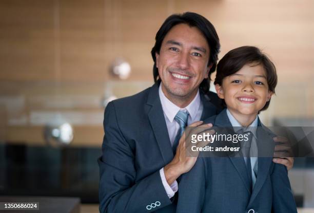 portrait of a happy business man dressed in a suit with his son - father son admiration stock pictures, royalty-free photos & images