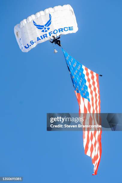 An Air Force parachuter flies into the stadium with a United States flag before the game between the Nebraska Cornhuskers and the Purdue Boilermakers...