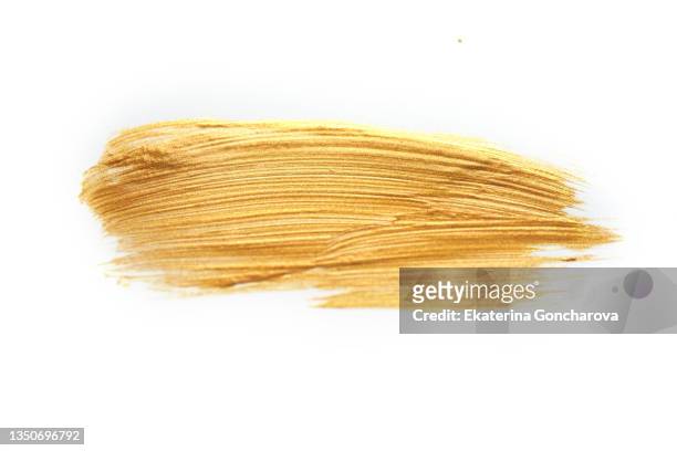 a golden smear on a white isolated background - colpire foto e immagini stock