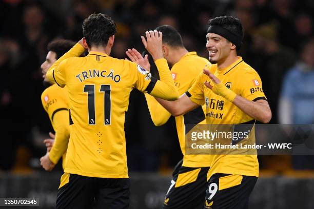 Raul Jimenez of Wolverhampton Wanderers celebrates with Francisco Trincao after scoring their team's second goal during the Premier League match...
