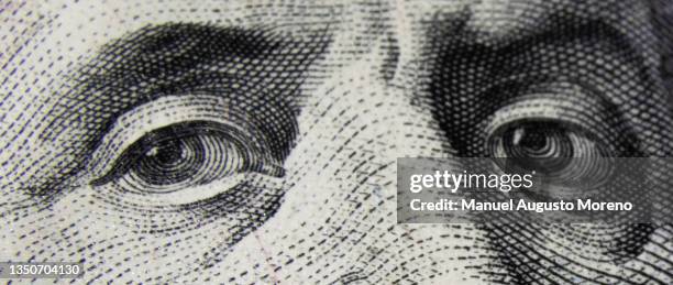 eyes of the portrait of benjamin franklin - 100 dollar banknote - 100 bills stock pictures, royalty-free photos & images
