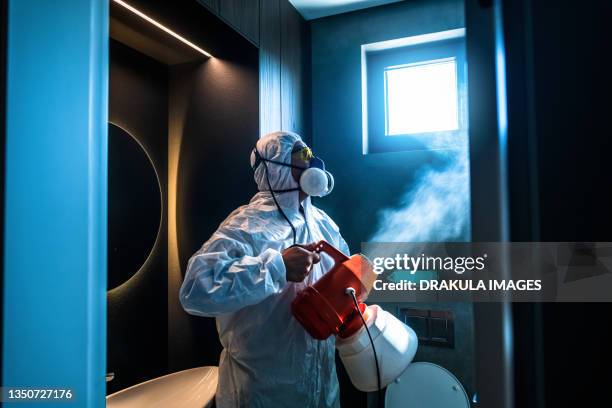 disinfection during a covid -19 pandemic - roupa protetora imagens e fotografias de stock