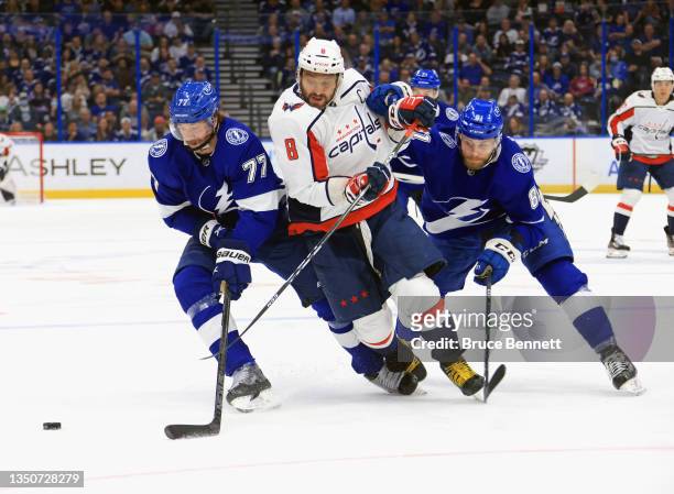 Victor Hedman and Erik Cernak of the Tampa Bay Lightning combine to try to stop Alex Ovechkin of the Washington Capitals during the first period at...